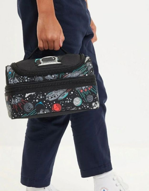 Child holding Smiggle Space Astronaut Double Decker Lunchbox with galaxy print
