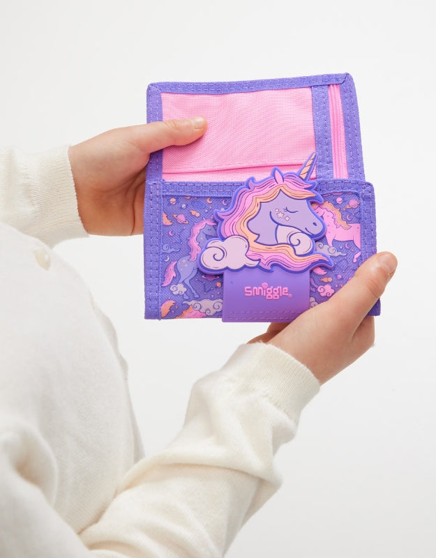 Child holding closed Smiggle Unicorn Pink Wallet with 3D unicorn detail