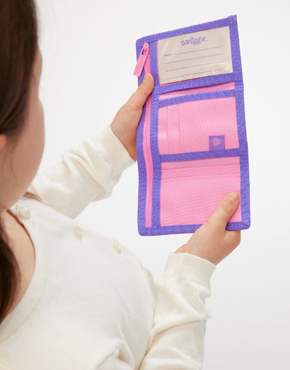 Child holding open Smiggle Unicorn Pink Wallet showing compartments