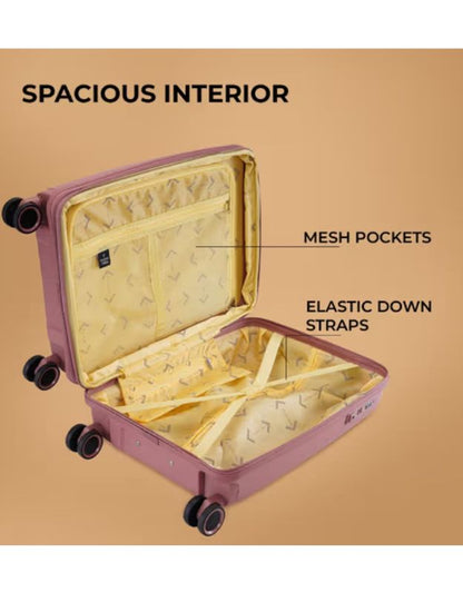 Spacious interior of rose pink luggage with mesh pockets and elastic straps.