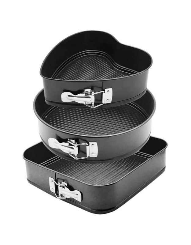 Set of three black nesting cake pans on a white background. Stack of nonstick springform cake pans in round, square, and heart shape.