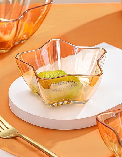 Transparent gold star-shaped glass bowl with kiwi slices inside