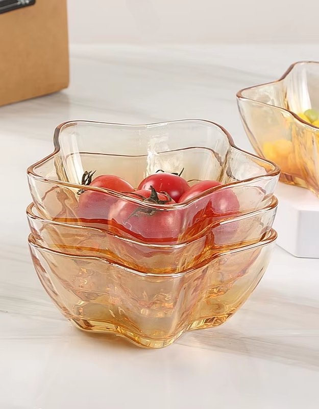 Stack of star-shaped glass bowls with fresh cherry tomatoes