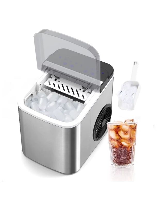 Portable ice maker with a glass of iced coffee on a white background. Stainless steel countertop ice maker with transparent lid open and ice cubes inside.