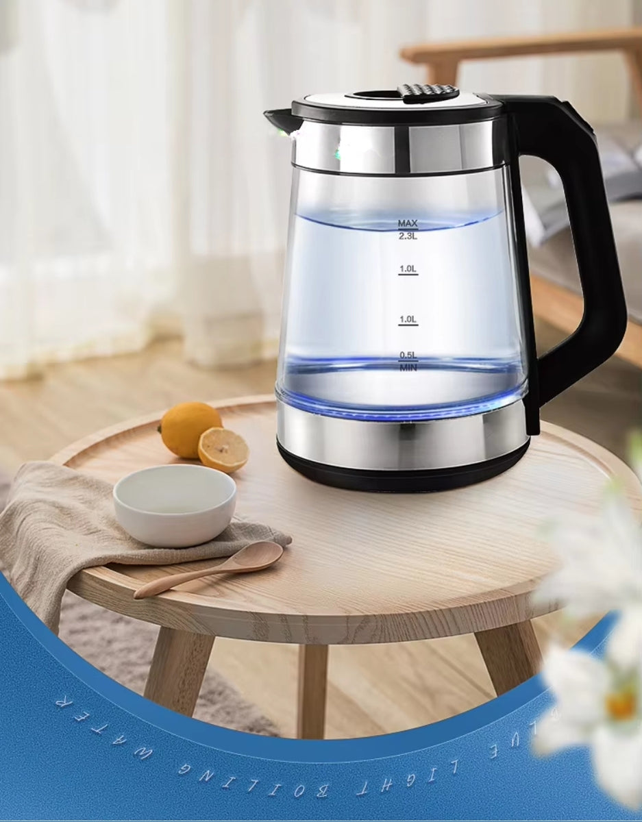 Super Crest glass electric kettle with blue LED boiling light placed on a wooden table with lemons and a cup