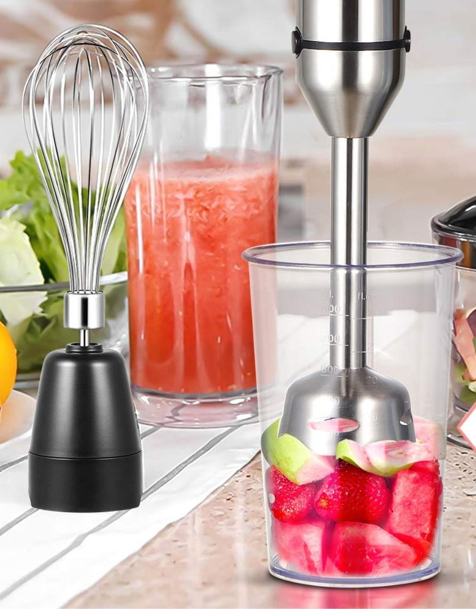 Super Crest 1-Speed electric hand blender blending fruits for fresh juice, with whisk attachment beside it on a kitchen counter