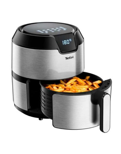 Tefal air fryer open with crispy golden French fries inside basket.