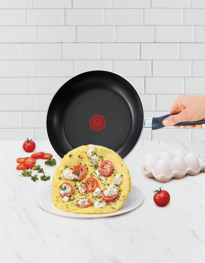 Tefal non-stick frying pan cooking omelette with tomatoes and cheese – titanium coating surface