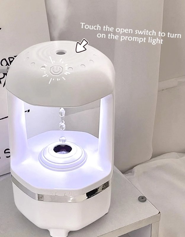 White humidifier with LED light on a table. Touch control humidifier with light indicator and mist function.