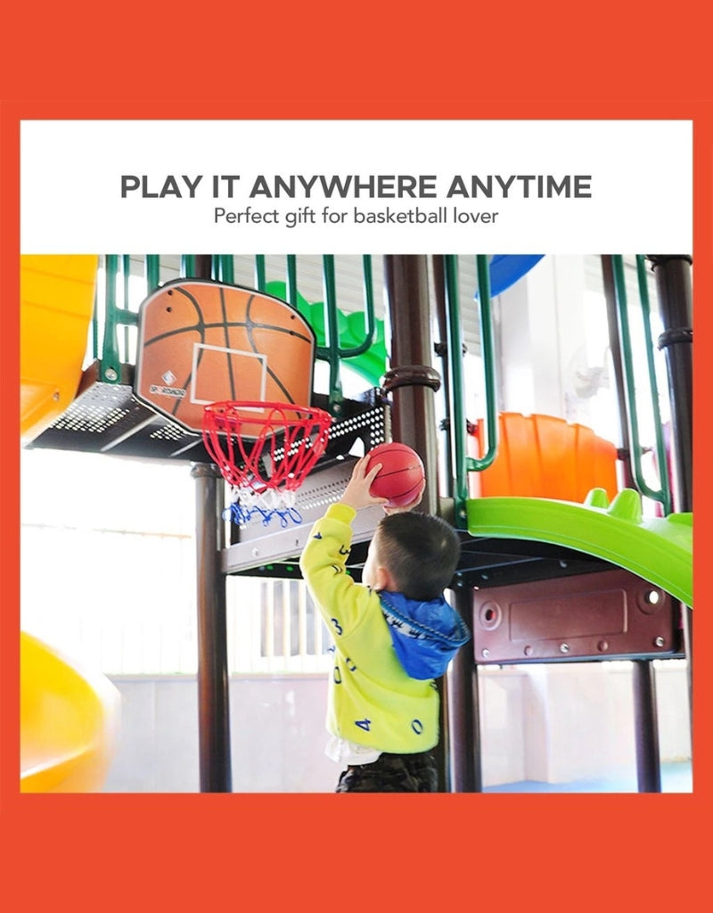 Child playing with the Tournament Indoor Basketball Hoop Set mounted on a playroom structure.