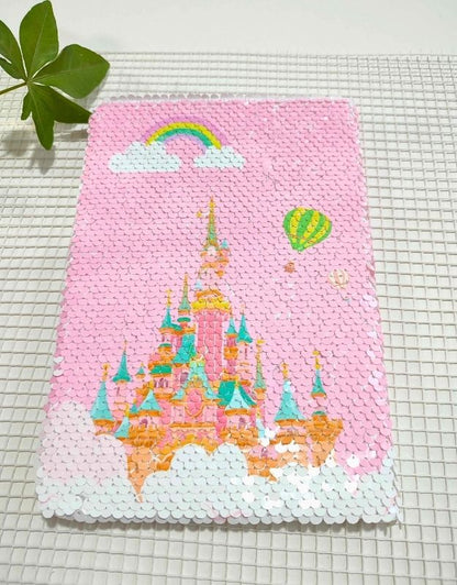 Pink sequin panel with a castle design on a grid background