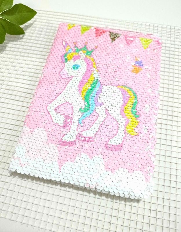 Sequined notebook with a unicorn design on a grid background