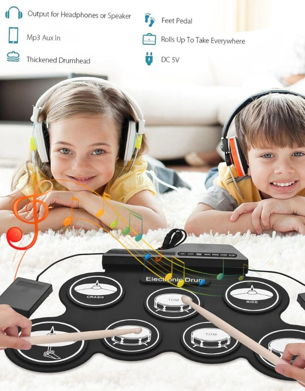 All the contents of the USB portable electronic drum kit laid out, including the main drum pad, two foot pedals, drumsticks, USB and audio cables, and the instruction manual