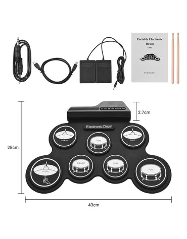  A close-up photo of a young girl seated on the floor, using a drumstick to play the portable electronic drum kit.