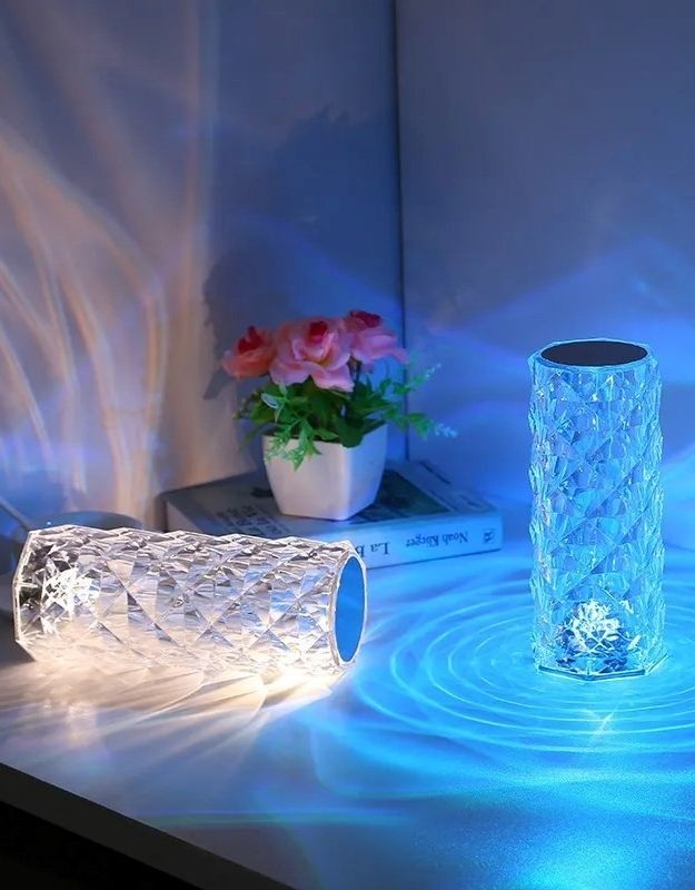 Rechargeable crystal touch lamp creating romantic blue glow on table.
