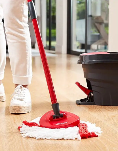 Vileda Turbo spin mop cleaning wooden floor with microfiber head.