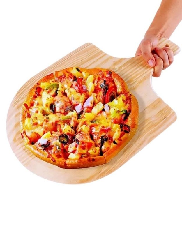 Wooden pizza peel with a pizza on a white background. Hand holding a wooden pizza peel serving a fresh baked pizza with toppings.